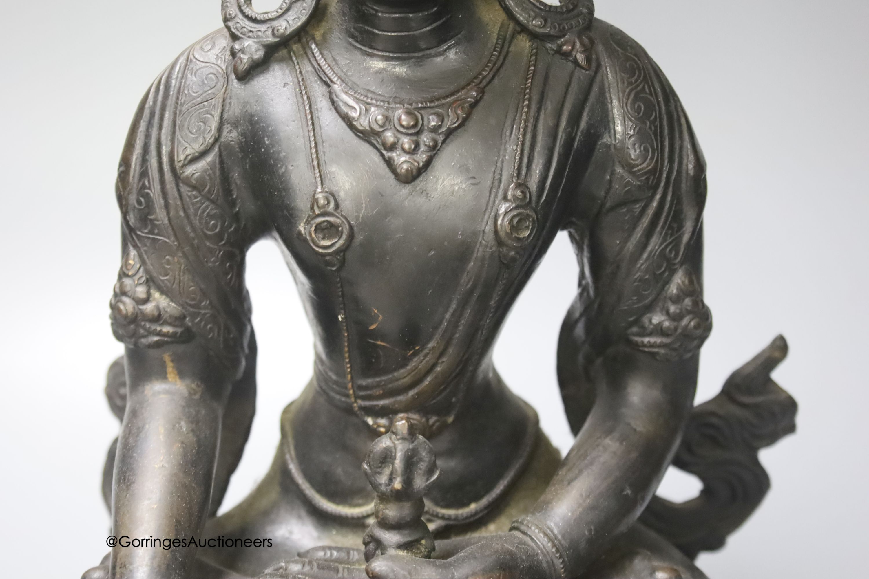 A bronze figure of a Bodhisattva, seated on an oval lotus base, 36cm